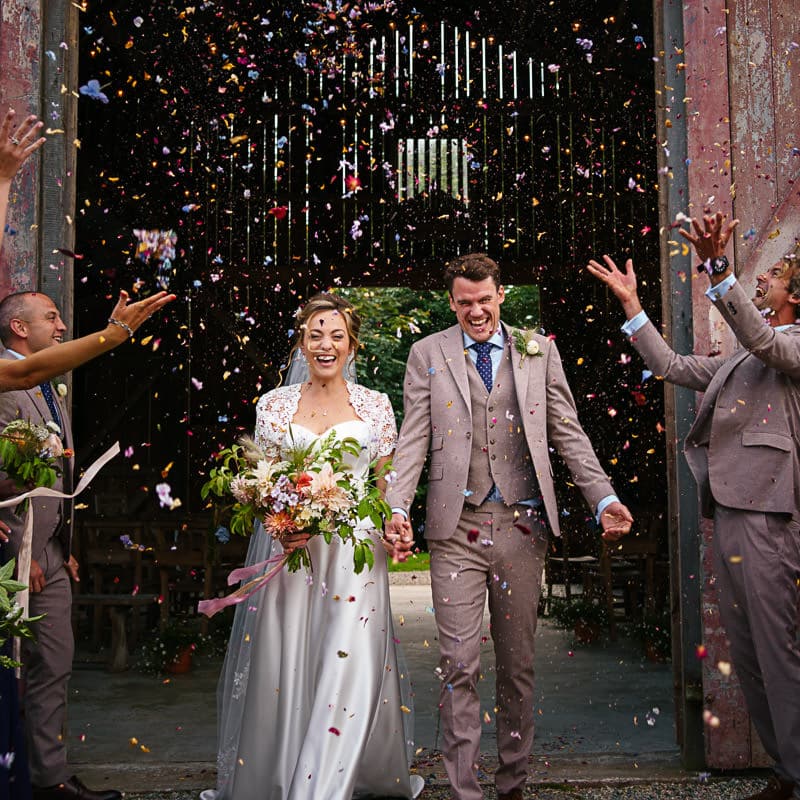 Colourful confetti throw at Devon barn wedding